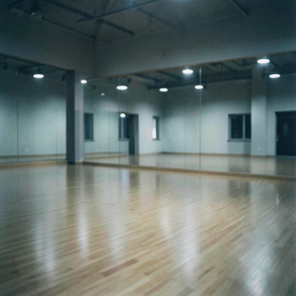 Image of an empty urban dance studio at night with a mirrored wall