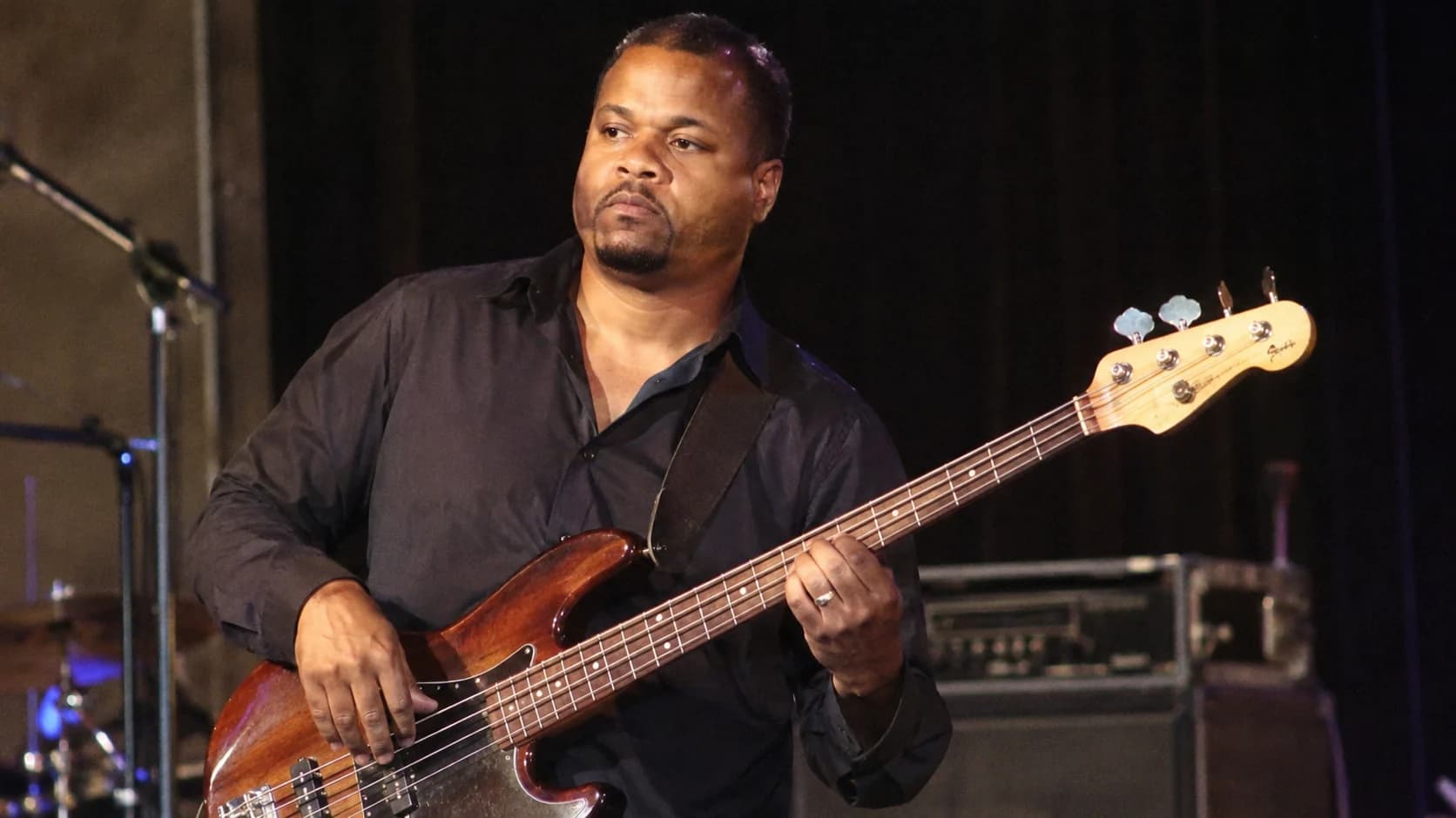 Thomas Gooding, also known as Tommy Gooding, playing bass guitar during a music rehearsal.